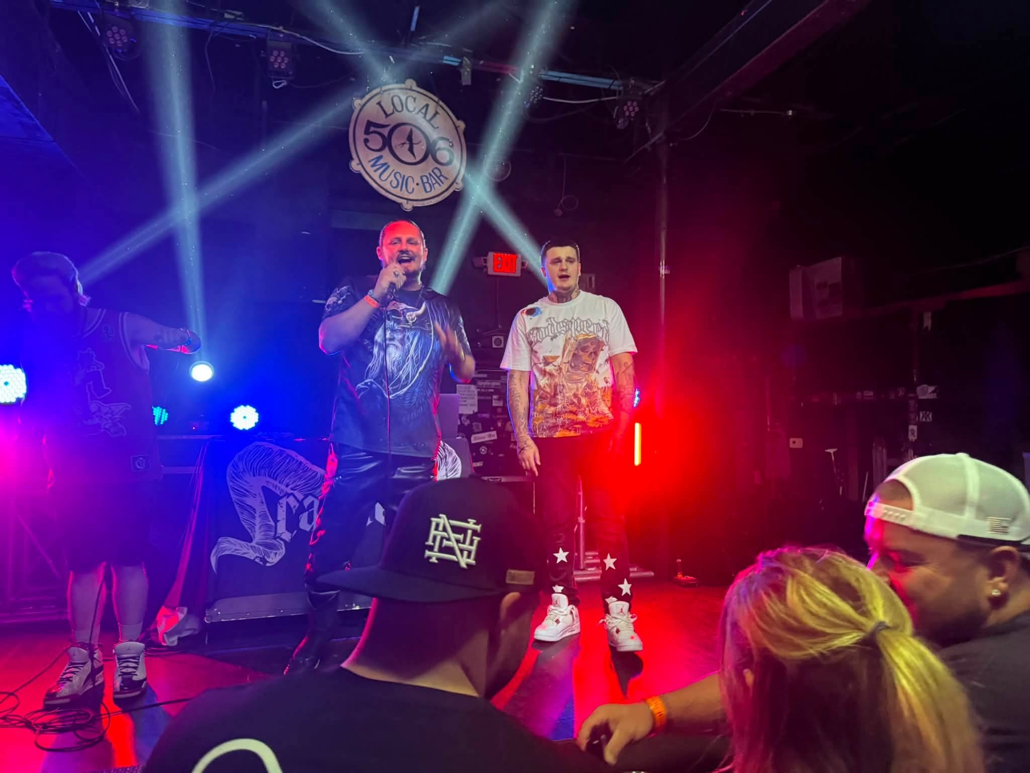 Kaspa Killa performing under red and blue stage lights