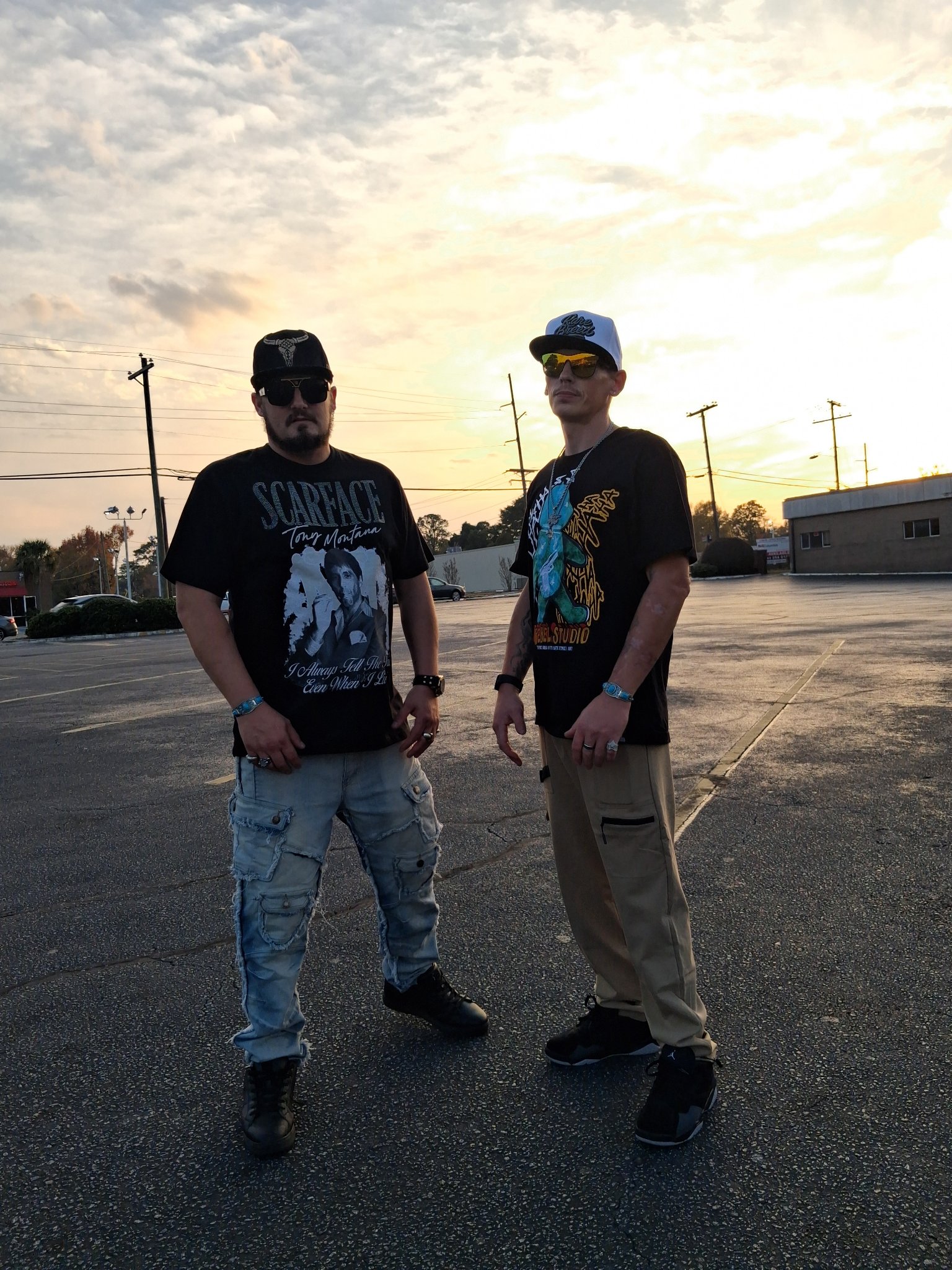 Kaspa Killa with $toney in a parking lot at sunset